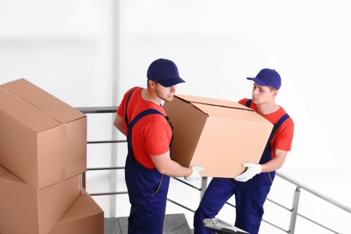 Movers using safe lifting practices during a home removal