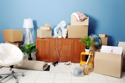 Same day removals in Canary Wharf with movers using equipment in a city apartment building