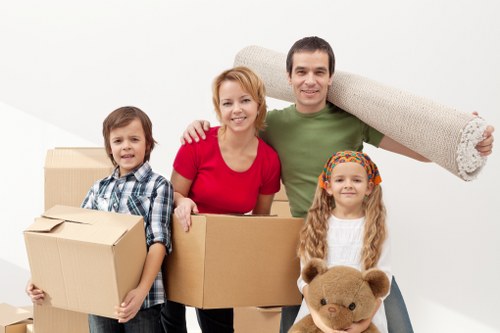 Professional movers carrying furniture through a managed building entrance