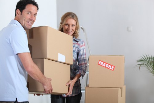 Mover wearing PPE while handling furniture in a secure loading area