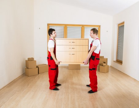 Moving crew handling packed boxes during a UK service booking